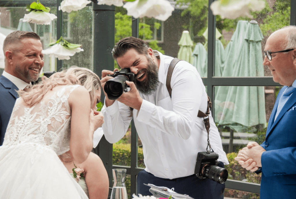 Lachende fotograaf maickel braakman bij een bruiloft
